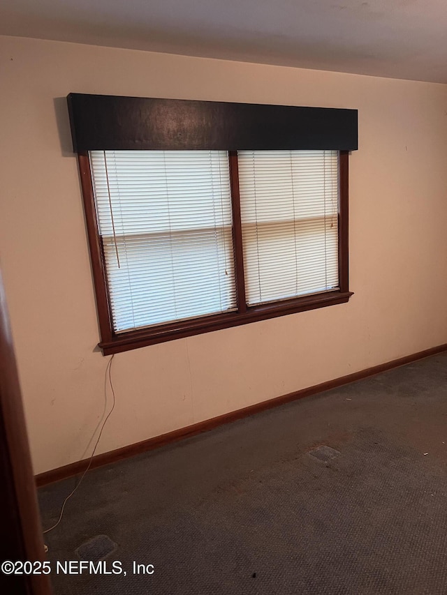 empty room featuring dark carpet