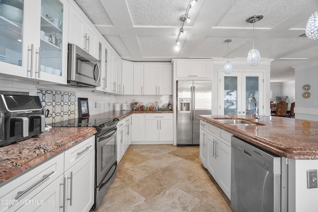 1387 Dunns Lake Dr, Jacksonville, FL 32218 - kitchen with sink, decorative light fixtures, appliances with stainless steel finishes, white cabinets, and backsplash
