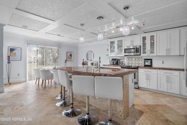 1387 Dunns Lake Dr, Jacksonville, FL 32218 - kitchen with sink, appliances with stainless steel finishes, white cabinetry, a kitchen island with sink, and decorative light fixtures