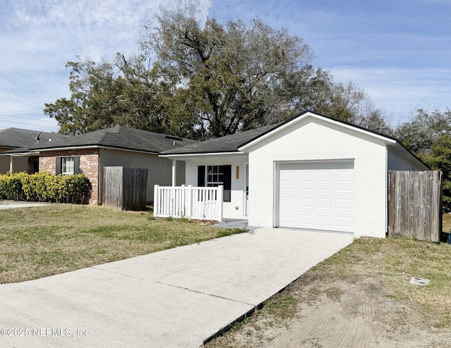 ranch-style home featuring a garage, a front yard, and covered porch