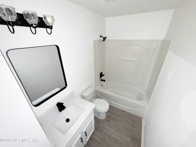 full bathroom featuring vanity, hardwood / wood-style flooring,  shower combination, and toilet