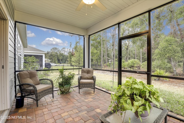 sunroom featuring ceiling fan