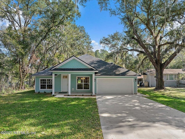 view of front of property featuring a garage, a front lawn, and a porch