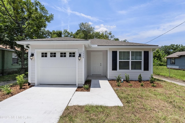 ranch-style house with a garage and a front lawn