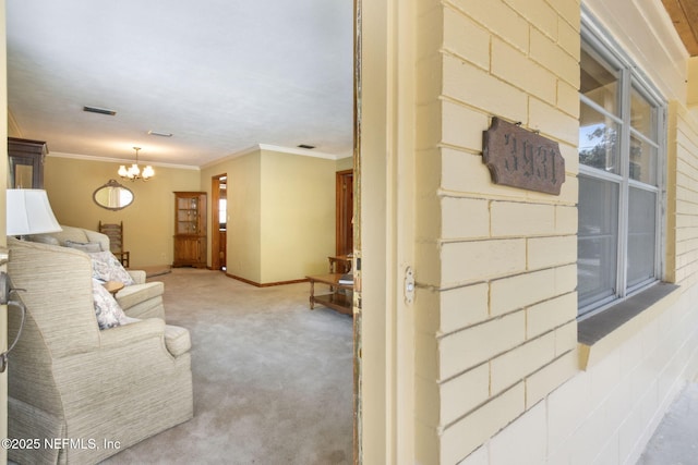 living room featuring crown molding, carpet, and a notable chandelier