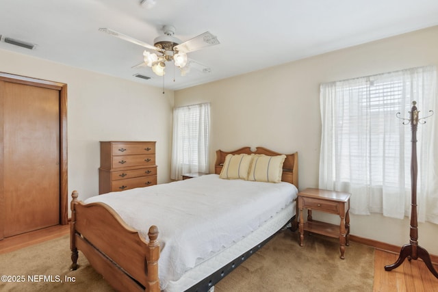 bedroom with ceiling fan and light hardwood / wood-style flooring