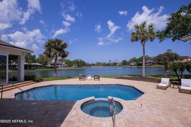 view of pool featuring a patio area, a pool with connected hot tub, and a water view