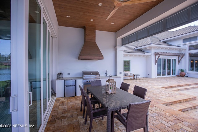 view of patio featuring outdoor dining area, grilling area, and area for grilling