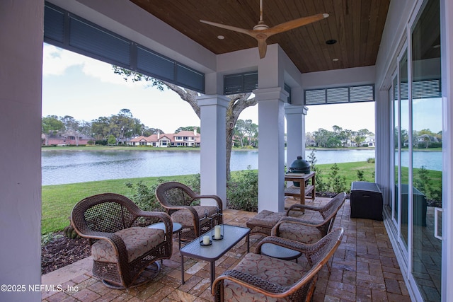view of patio / terrace with an outdoor living space, ceiling fan, and a water view