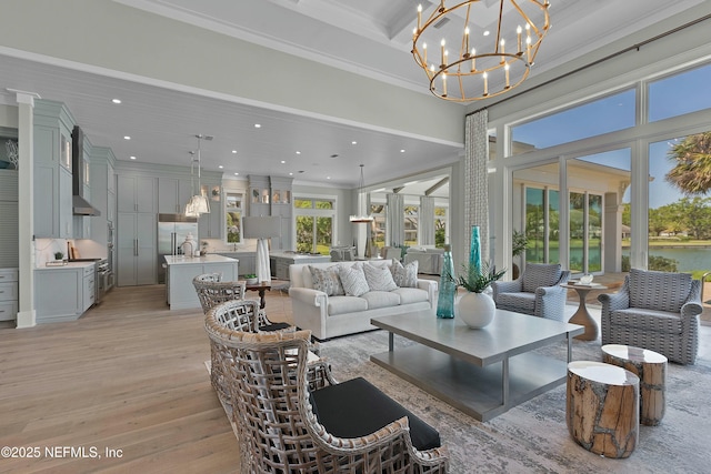 living room with crown molding, recessed lighting, a high ceiling, light wood finished floors, and beam ceiling