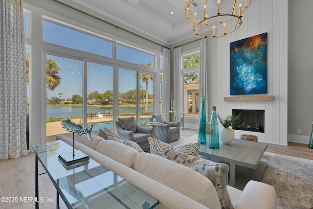 sunroom with a water view, beamed ceiling, and an inviting chandelier