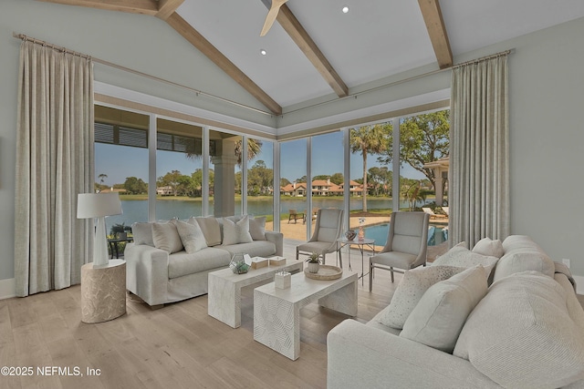 sunroom / solarium with a water view and beamed ceiling