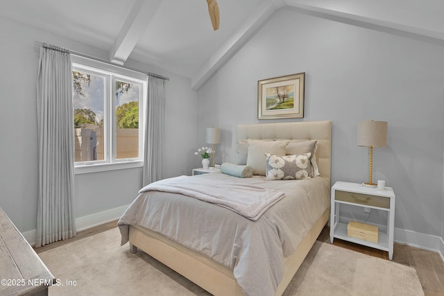 bedroom with lofted ceiling with beams, baseboards, and wood finished floors