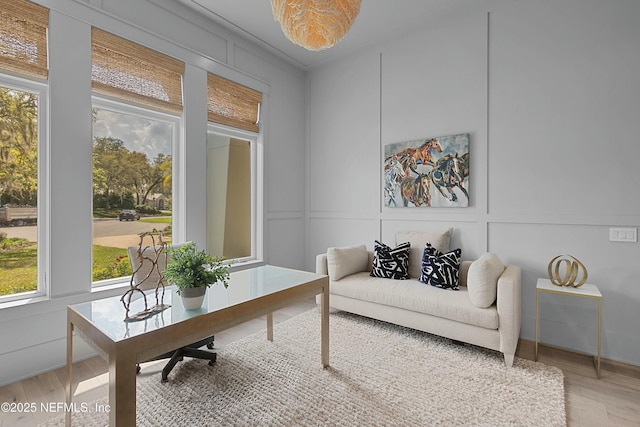 interior space featuring light wood-style floors and a decorative wall