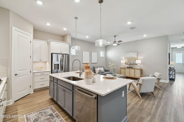 kitchen with a sink, visible vents, gray cabinets, and stainless steel appliances