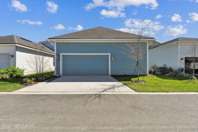 view of front of property with a garage, a front yard, central AC, and driveway