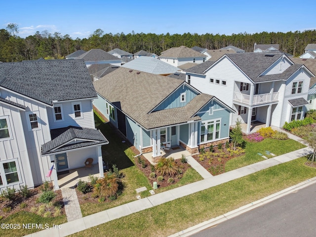 birds eye view of property with a residential view