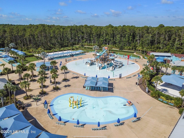 birds eye view of property featuring a view of trees