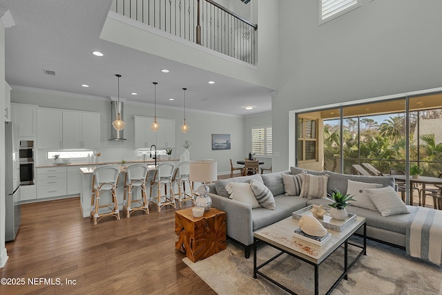 living room featuring ornamental molding and hardwood / wood-style floors