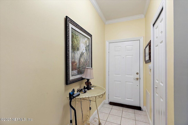 doorway with baseboards, crown molding, and light tile patterned flooring