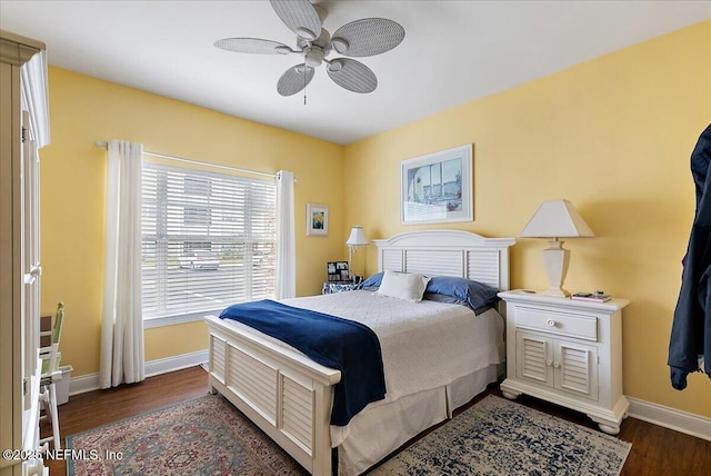 bedroom with ceiling fan, baseboards, and wood finished floors