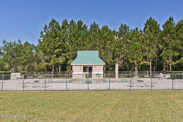 exterior space featuring fence and a lawn