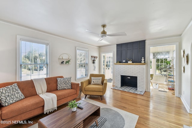 758 Acosta St, Jacksonville, FL 32204 - living room featuring ceiling fan, ornamental molding, a brick fireplace, and light hardwood / wood-style flooring