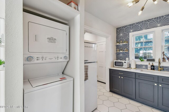 758 Acosta St, Jacksonville, FL 32204 - washroom with stacked washer and dryer and sink