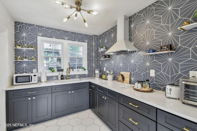 758 Acosta St, Jacksonville, FL 32204 - kitchen featuring range hood, sink, light tile patterned floors, a notable chandelier, and white appliances
