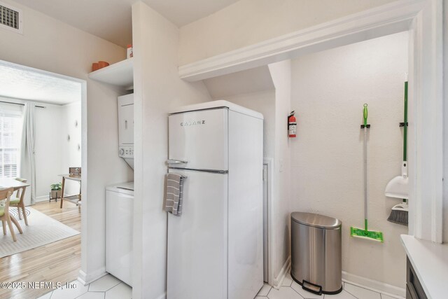 758 Acosta St, Jacksonville, FL 32204 - kitchen featuring white refrigerator and light tile patterned floors