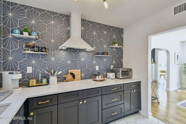 758 Acosta St, Jacksonville, FL 32204 - kitchen with white electric stovetop, wall chimney range hood, and backsplash