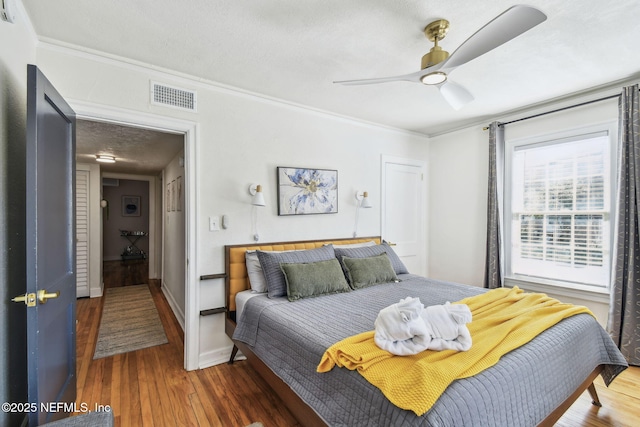 758 Acosta St, Jacksonville, FL 32204 - bedroom featuring ornamental molding, dark hardwood / wood-style floors, a textured ceiling, and ceiling fan