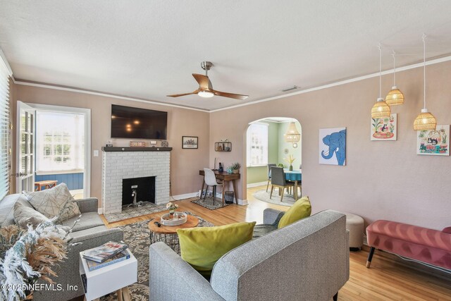 758 Acosta St, Jacksonville, FL 32204 - living room featuring ornamental molding, a brick fireplace, wood-type flooring, and ceiling fan