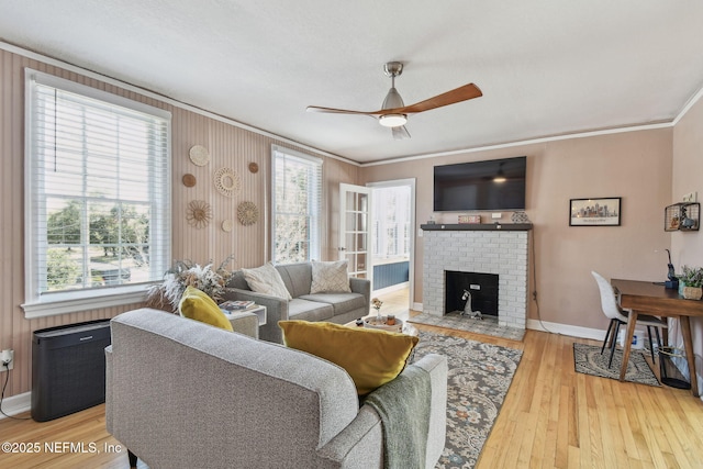 758 Acosta St, Jacksonville, FL 32204 - living room featuring ceiling fan, ornamental molding, a fireplace, and wood-type flooring