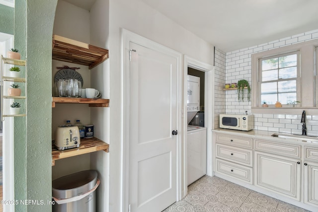 758 Acosta St, Jacksonville, FL 32204 - pantry featuring stacked washer and dryer and sink