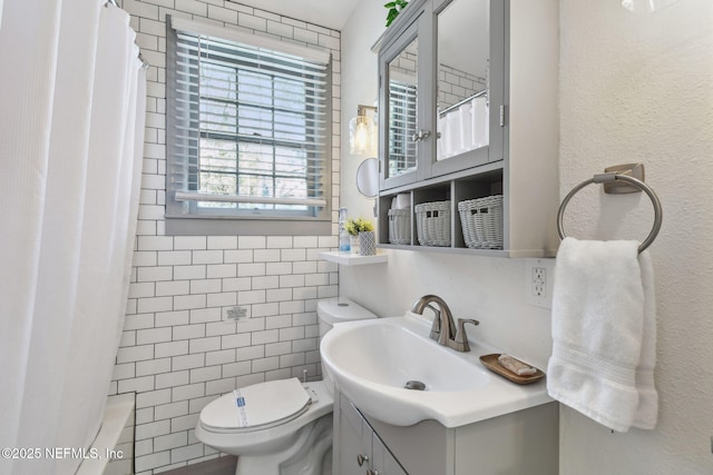 758 Acosta St, Jacksonville, FL 32204 - bathroom with vanity, tile walls, and toilet