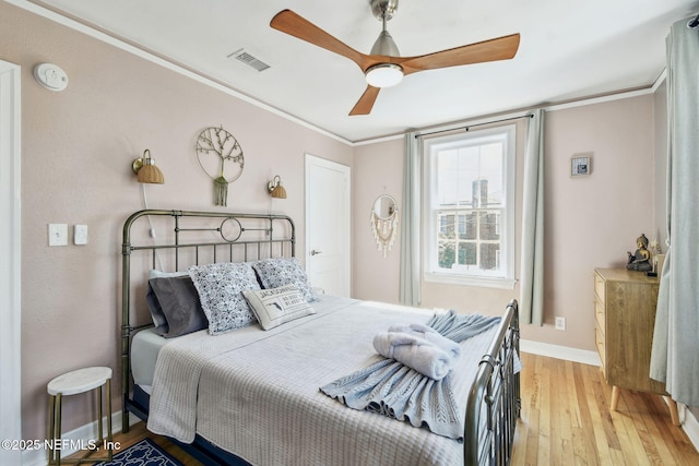 758 Acosta St, Jacksonville, FL 32204 - bedroom with ceiling fan, ornamental molding, and light hardwood / wood-style flooring