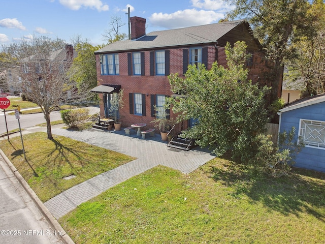758 Acosta St, Jacksonville, FL 32204 - colonial home featuring a patio area and a front lawn