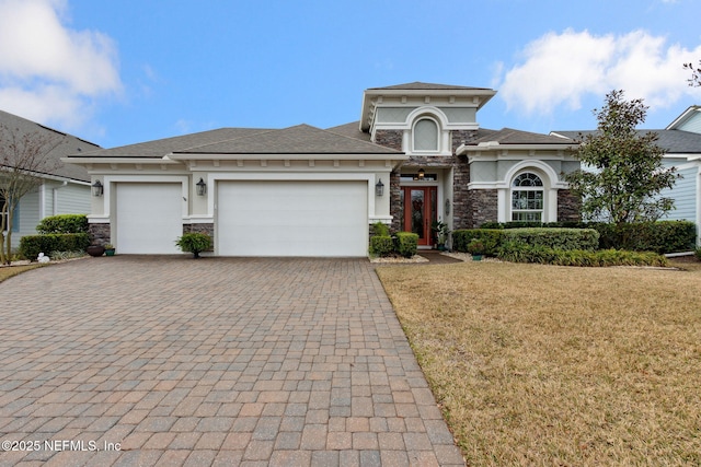 view of front of home with a garage and a front yard