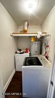 washroom with laundry area, independent washer and dryer, and baseboards