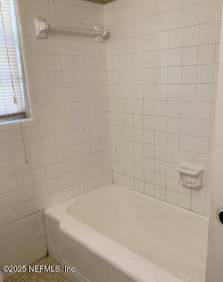 full bathroom with bathtub / shower combination and tile walls