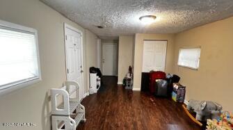 interior space featuring a textured ceiling and wood finished floors