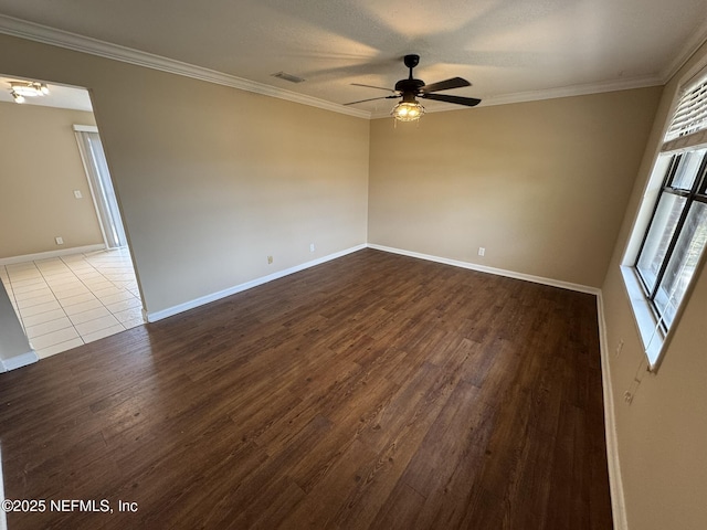 empty room featuring ornamental molding and wood-type flooring