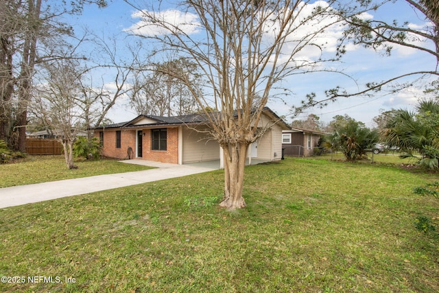 ranch-style house featuring a garage and a front lawn