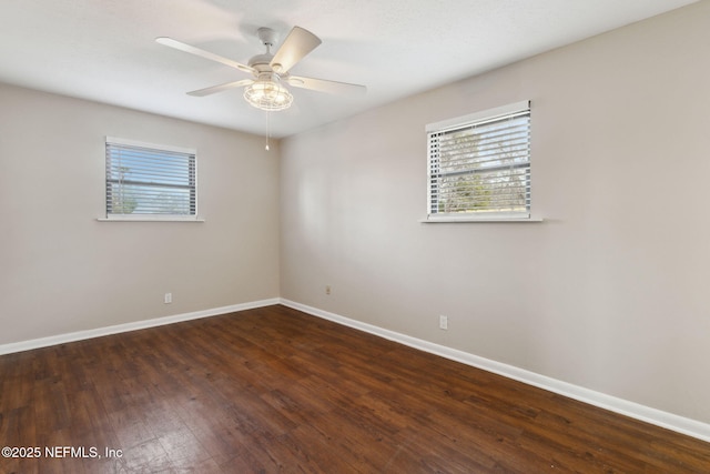 unfurnished room featuring dark wood-type flooring and ceiling fan