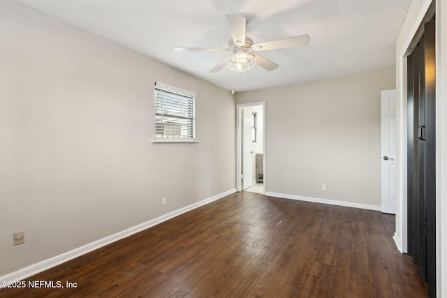 unfurnished room with dark hardwood / wood-style flooring and ceiling fan