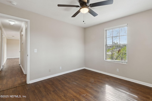 spare room with ceiling fan and dark hardwood / wood-style flooring