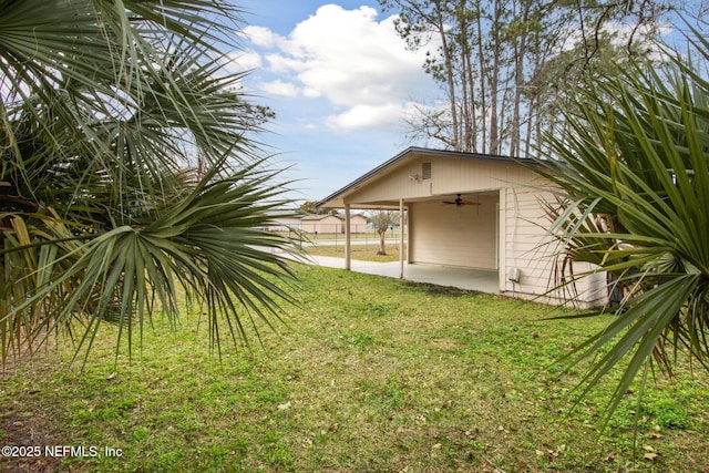 view of yard with ceiling fan and a patio