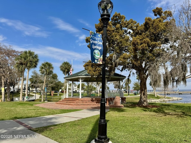 surrounding community with a gazebo, a water view, and a yard