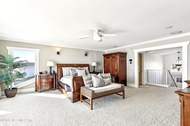 bedroom featuring light carpet, ornamental molding, visible vents, and baseboards